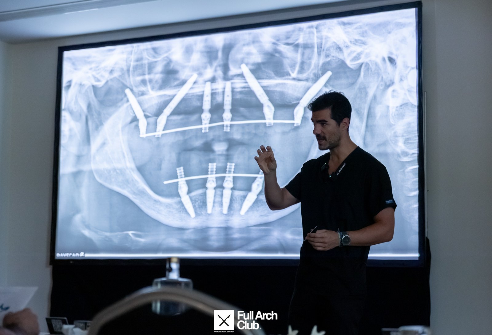 Dr. Bernardo Sousa teaching implant positioning over a full-arch X-ray